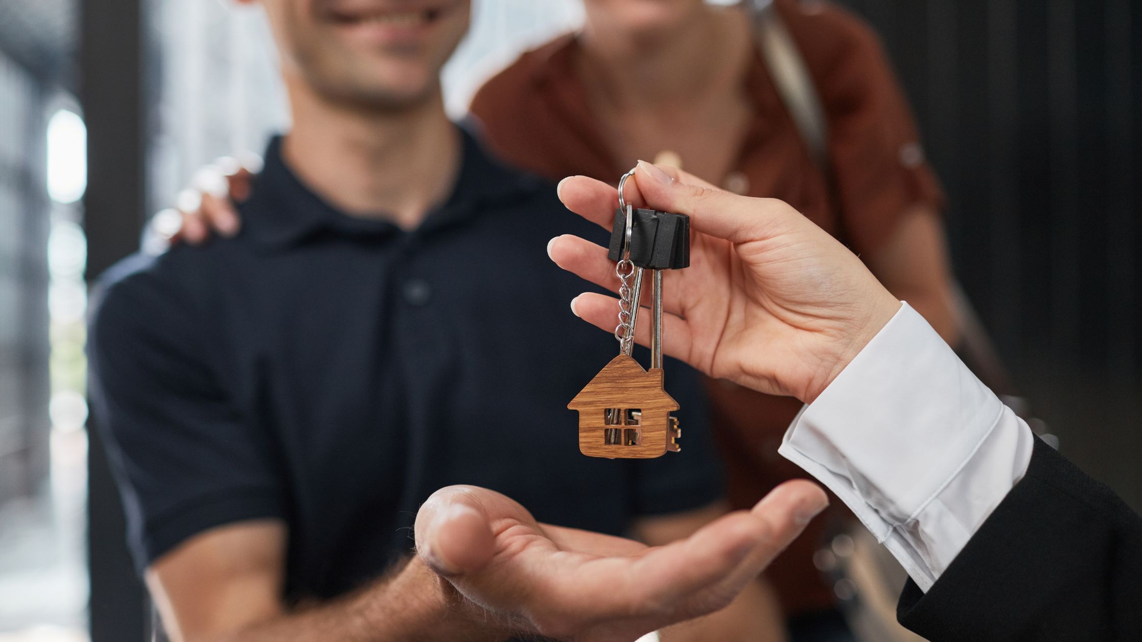 A couple being handed the keys to their new home