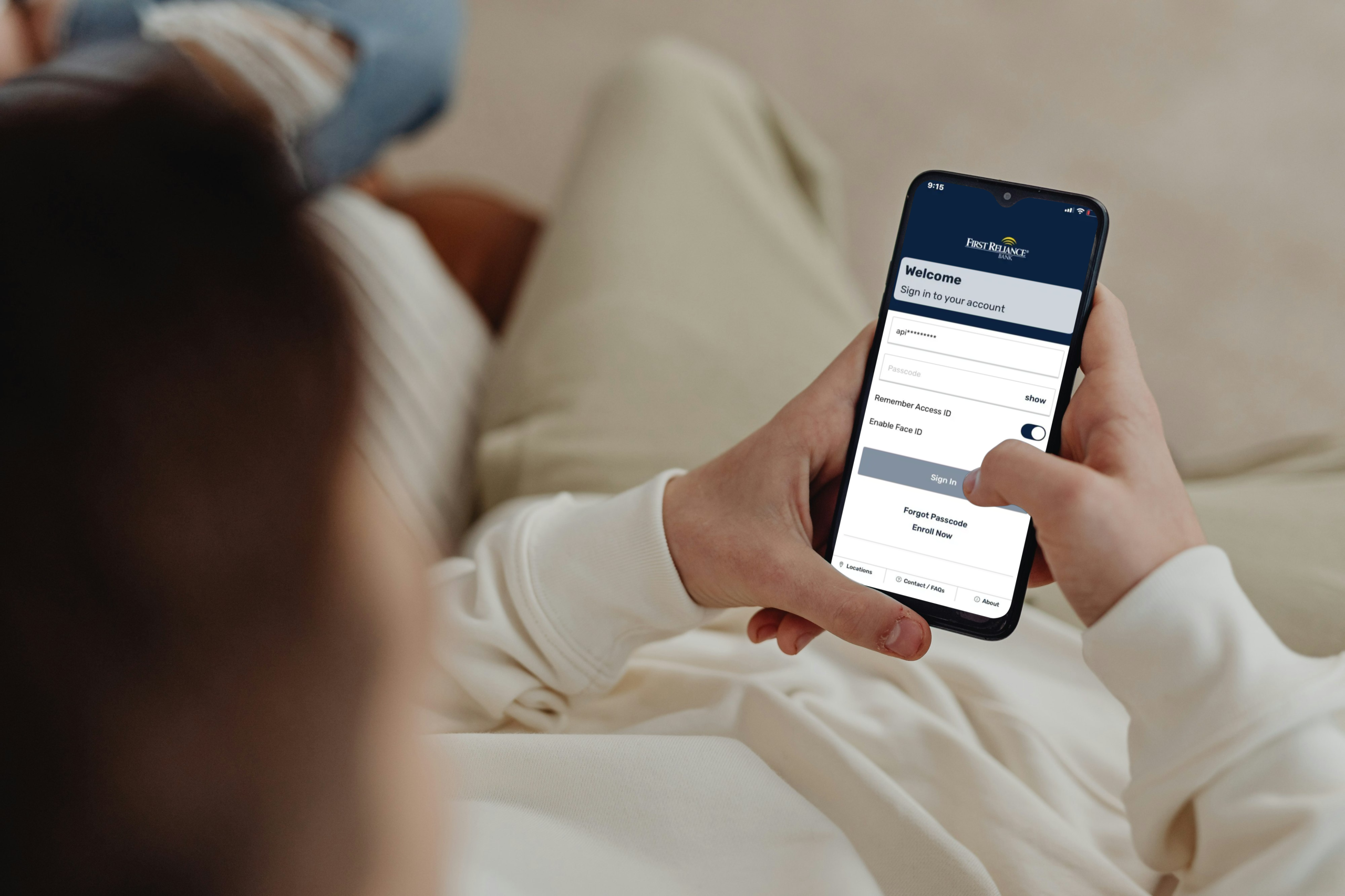Person logging into First Reliance Mobile Banking.